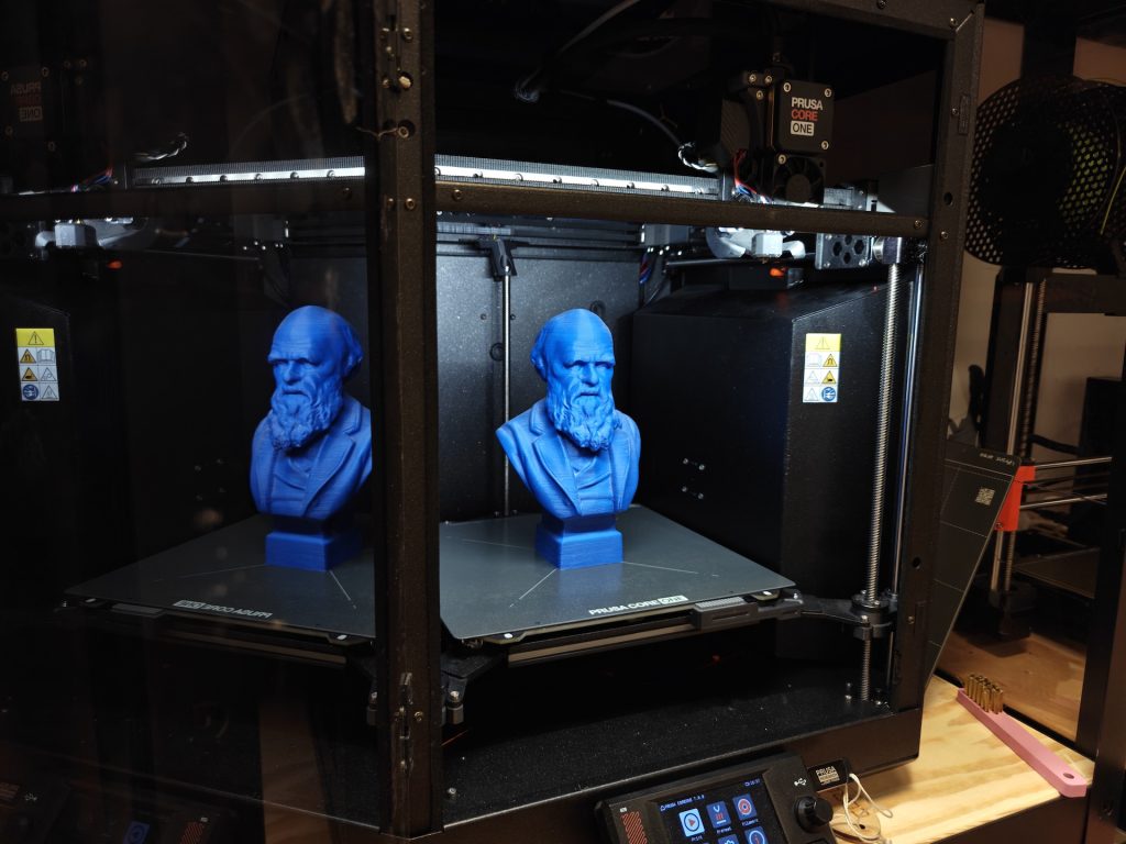 Prusa CoreOne 3D printer with two printed busts